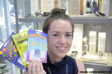 Morgan Price with the Buy Local gift cards at W J Coote &amp; Sons (jewellery). Photo:CHRIS SEABROOK 122116card1